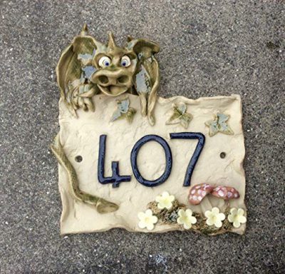 Dragon sitting on top of house number plaque